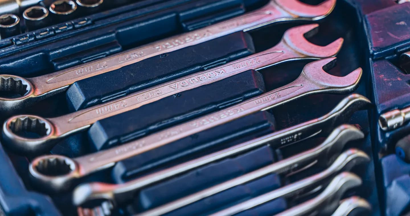 Set of metal spanners laid out in a tool tray