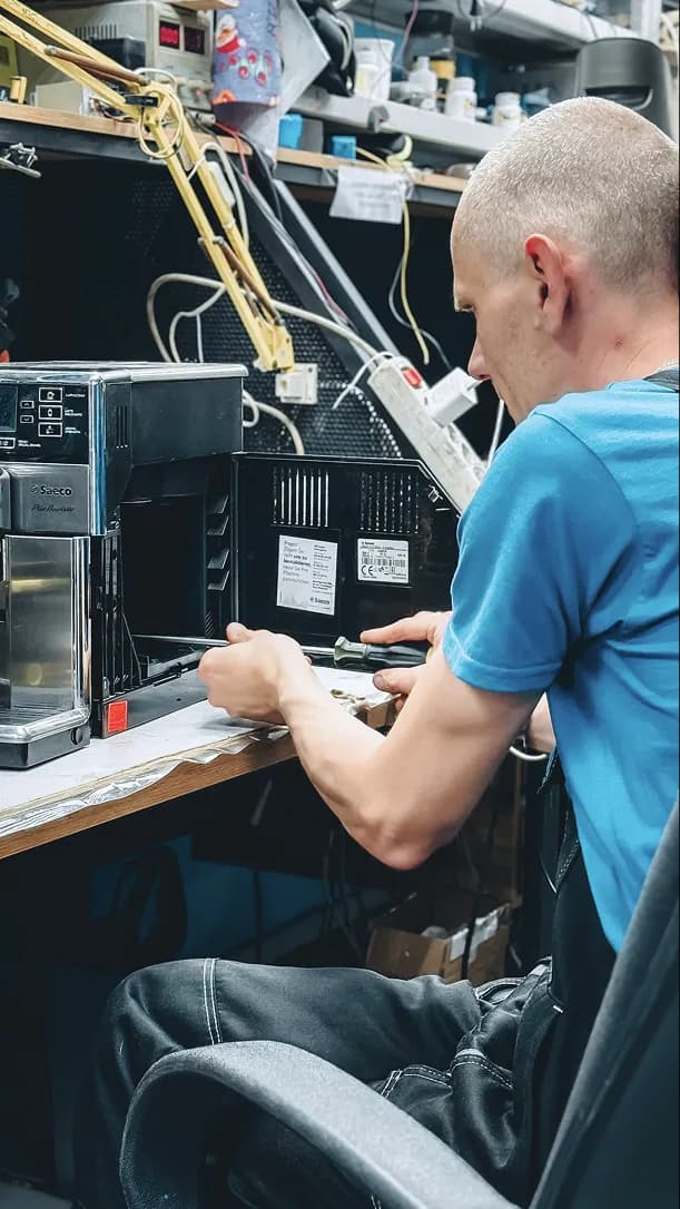 Technician repairing the internal wiring of an appliance