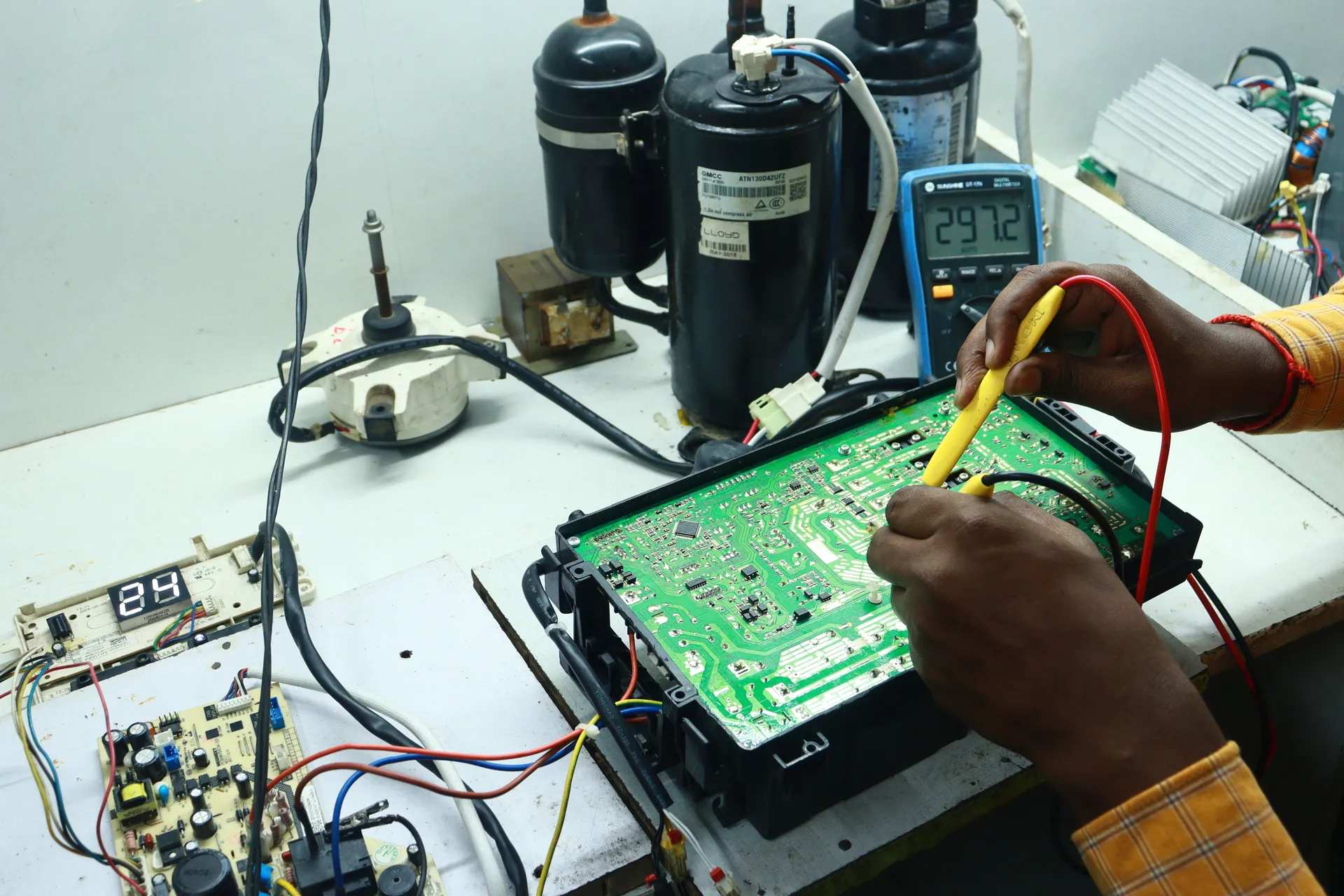 Technician inspecting a washing machine in a Bangalore home
